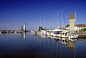 Boats are moored at harbour in the sunlight, Lindau, Lake Constance, Baden Wurttemberg, Germany