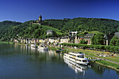 Reichsburg under blue sky and excursion boats at the riverbank, Mosel, Rhineland-Palatinate, Germany