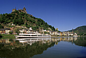 Reichsburg under blue sky and excursion boat on the river, Mosel, Rhineland-Palatinate, Germany