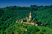 Reichsburg amidst green trees in the sunlight, Rhineland-Palatinate, Germany