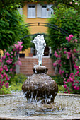 Fountain in the garden of Restaurant Villino, Lindau, Lake Constance, Germany