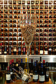 Well-stocked wine rack and a glass filled with corks at the Restaurant Azur, The Twelve Apostles HotelSouth Africa, Africa