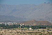 Houses in a distance in front of mountains, Al Hajar  mountains, Oman, Asia, Oman, Asia