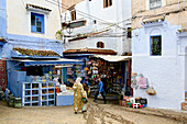People walking through the alleys of Chefchaouen's medina, Chefchaouen, Morocco, Africa