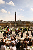 People in a sidewalk cafe, view at the New Castle with Jubilaeumssaeule, Palace Square, Stuttgart, Baden-Wurttemberg, Germany