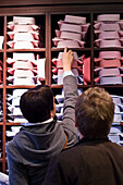 A couple in a mens clothes shop looking at shirts, Ingolstadt, Bavaria, Germany