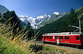 Red Train of Rhaetische Bahn in front of mountain range of Bellavista, Piz Argient, Crast Agüzza, Piz Bernina, Piz Prievlus and Piz Morteratsch, Ferrovia Raetia, Bernina range, Bernina, Morteratsch, Oberengadin, Engadin, Grisons, Switzerland