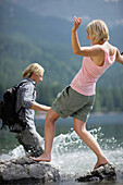 Young couple in lake Eibsee, Werdenfelser Land, Bavaria, Germany