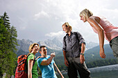 Four young people at lake Eibsee, Werdenfelser Land, Bavaria, Germany