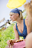 Young woman eating a pretzel, Werdenfelser Land, Bavaria, Germany