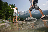 Four young people at lake Eibsee, Werdenfelser Land, Bavaria, Germany
