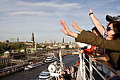 Passengers waving on the cruise ship AidaDiva, Hamburg, Germany