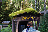 A man at mossy call booth at Olympic Nationalpark, Washington, USA