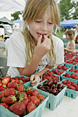 Farmer's Market, locally grown produce, vegetable, girl, strawberry, raspberry, cherry. Purcellville. Virginia. USA.