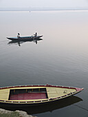 Boats with pilgrims and tourists at dawn in Varanasi, India, a sacred Hindu pilgrimage site.