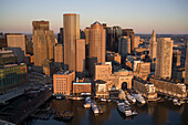 Skyline at sunrise, from harbor, aerial view with Rowes Wharf & Boston Harbor Hotel center, Boston, Usa.