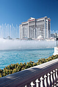 The dancing fountains at The Belagio Hotel and Casino with Caesars Palace in the background in Las Vegas Nevada, USA.
