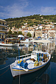 Pastel colored buildings on the waterfront and colorful fishing boats at the attractive fishing town of Githeo, Greece.