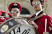 Musicians dressed in red costumes for the village Easter processions. Ispica. Sicily. Italy