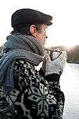 Senior man holding a cup, Lake Ammersee, Upper Bavaria, Germany