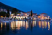 Illuminated houses at Bol harbour in the evening, Brac Island, Dalmatia, Croatia, Europe
