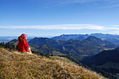Woman enjoying view from Kleiner Traithen, Bavarian foothills, Bavaria, Germany