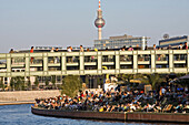 People at the bank of the river Spree and on Gustav-Heinemann bridge, Berlin, Germany, Europe