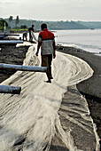 Fishermen spreading their nets on the beach, Eastern Bali, Indonesia, Asia