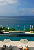 The infinity pool at the Amankila Resort in the sunlight, Candi Dasa, Eastern Bali, Indonesia, Asia