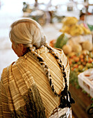 Indian woman with braids at the market at San Nicholas los Ranchos village, Puebla province, Mexico, America
