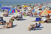Visitors to Fort Myers Beach Florida enjoy sun and water