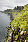 Dunite cliffs on the coast of Isle of Skye Scotland, Kilt Rock is in the distance.