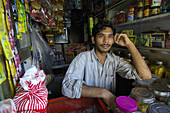 Young Indian man in his commodities shop in Santacruz district, Mumbai, Maharashtra, India