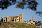 Castle, mudejar tower, church of Nuestra Señora del Mayor Dolor and bell gagle, Aracena, Sierra de Aracena y Picos de Aroche Natural Park. Huelva province, Andalucia, Spain