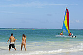 Couple and Catamaran at Maroma beach. Caribe. Quintana Roo state. Mayan Riviera. Yucatan Peninsula. Mexico