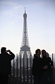 Visitors on top of Arc de Triomphe with Eiffle Tower in the background. Paris. France