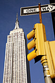 Empire State Building with traffic light in foreground. New York City. USA