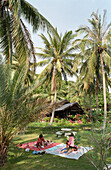 Thai massage under palm trees, Mae Hat Bay, Ko Pha Ngan, Thailand