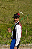 Shepherd, dairy farmer returning to the valley from the alpine pastures, Seiser Alm, South Tyrol, Italy