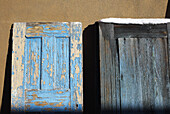 Two Weatehered Doors rest against adobe wall in Sante Fe, New Mexico.