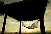 Hammock under tiki with Dania Beach FL pier in the background