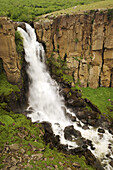 North Clear Creek Falls plunges over a cliff composed of ancient volcanic rock, San Juan Mountains, Colorado, USA