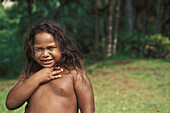 A local indiginous Palauian boy smiles to the camera