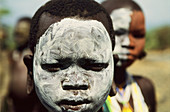 Portrait of a Surma girl, her face is painted in white ash color, Sudan