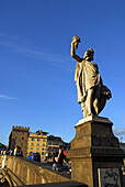 Statue in front of blue sky at Ponte Santa Trinita, Florence, Tuscany, Italy, Europe