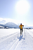 Woman cross-country skiing, Leitzach valley, Mangfall range, Upper Bavaria, Bavaria, Germany