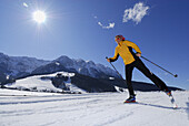 Woman cross-country skiing, Walchsee, Kaiser range, Tyrol, Austria