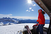Backcountry skier resting at alpine lodge, Grosser Gabler, Valle Isarco, Dolomites, Trentino-Alto Adige/Südtirol, Italy