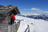Woman entering alpine hut, Grosser Gabler, Valle Isarco, Dolomites, Trentino-Alto Adige/Südtirol, Italy