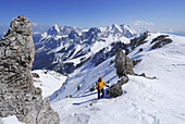 Woman backcountry skiing ascending summit of Hochwannig, Mieming range, Tyrol, Austria